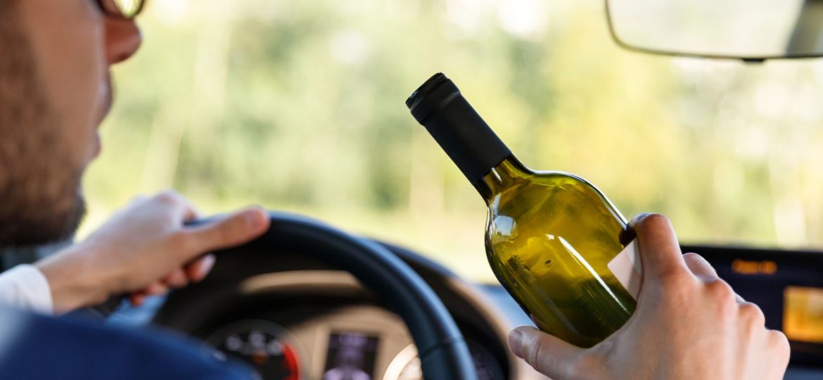 drunken-male-driving-a-car-with-a-bottle-of-alcoho-2022-02-08-04-33-05-utc (1) (Demo)